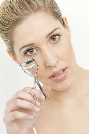 portrait of young woman making her eyelashesの写真素材