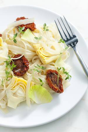 pasta with dried tomatoes and artichokesの写真素材