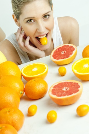 portrait of young woman with citrus fruitの写真素材