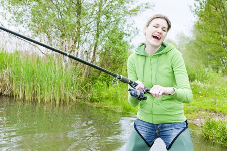 woman fishing in pondの写真素材
