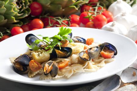 pasta with mussels, artichokes and cherry tomatoesの写真素材