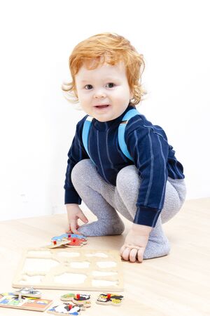 little boy playing with puzzleの写真素材