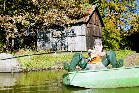 fishing woman sitting on boatの写真素材