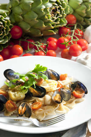 pasta with mussels, artichokes and cherry tomatoesの写真素材