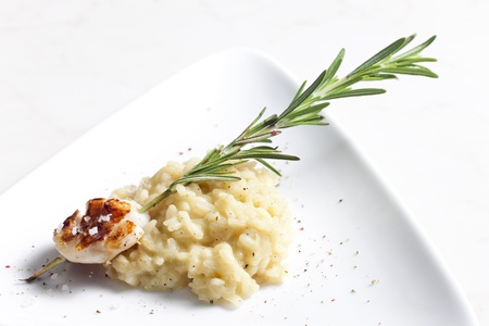 grilled Saint Jacques mollusc on rosemary needle with risottoの写真素材