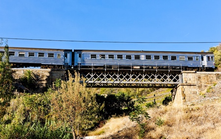 train on railway viaduct in Douro Valley, Portugalの写真素材