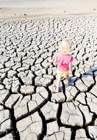 little girl standing on dry land, Parc Regional de Camargue, Provence, Franceの写真素材