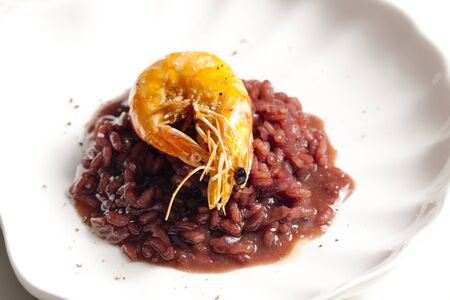 fried prawn on risotto steamed with red wineの写真素材