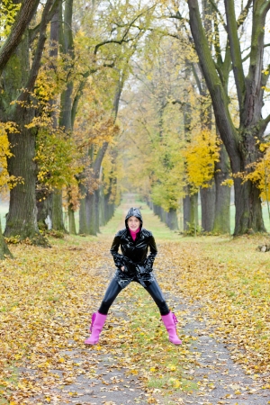 woman in autumnal alleyの写真素材