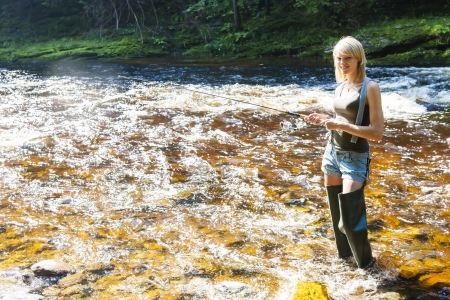 woman fishing in Jizera river, Czech Republicの写真素材