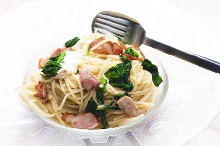 spaghetti with spinach, bacon and mozzarellaの写真素材