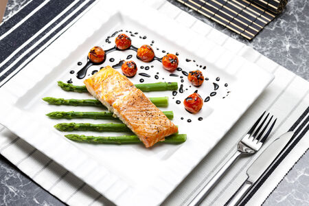 baked salmon with green asparagus and cherry tomatoesの写真素材