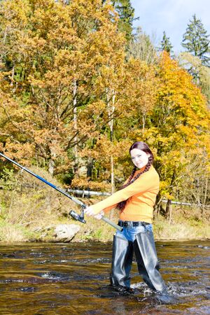 woman fishing in Otava river, Czech Republicの写真素材