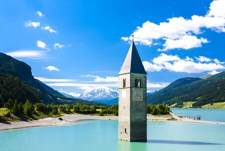 tower of sunken church in Resia lake, South Tyrol, Italyの写真素材