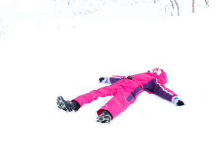 little girl playing in snowの写真素材