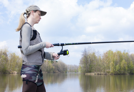woman fishing in pondの写真素材