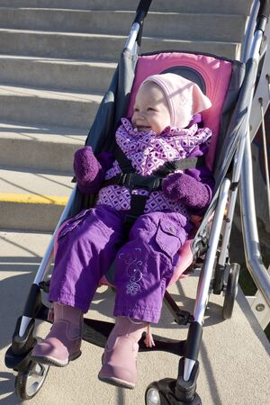toddler sitting in a pram