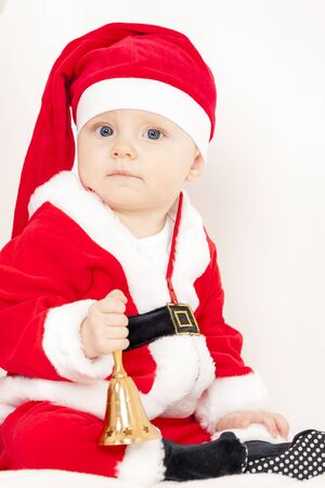 little girl as Santa Claus with a bellの写真素材