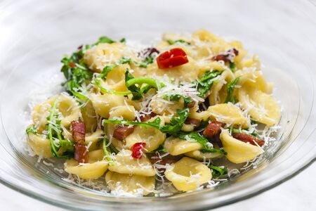 pasta orecchiette with ruccola and baconの写真素材