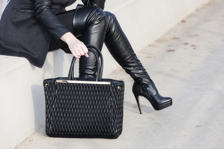 detail woman wearing boots with a handbagの写真素材