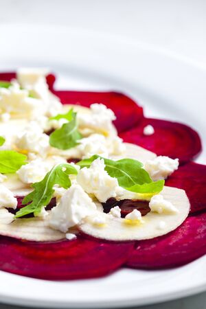 fresh beetroot and apple salad with fresh goat cheese and arugulaの写真素材