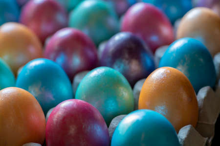 Easter background with hand painted purple, blue, green, orange