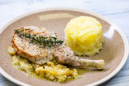 pork chop with thyme baked on creamy onion with mashed potatoesの写真素材
