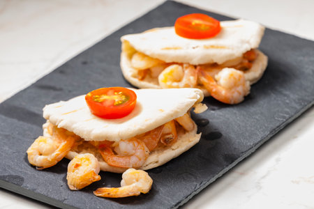 pitta bread filled with shrimps and tomatoesの写真素材