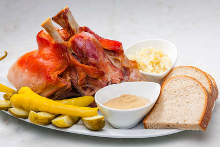 roasted pork knee with picked vegetables, bread and mustardの写真素材