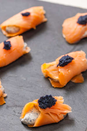 smoked salmon rolls filled with cream cheese and black caviar