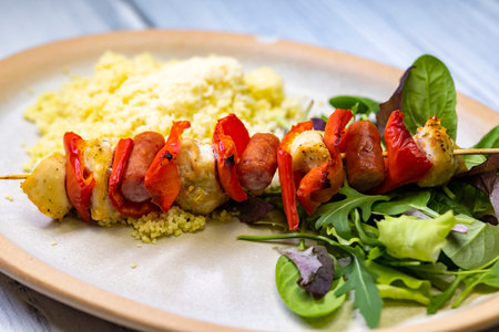 Chicken skewer with red pepper and sausageの写真素材