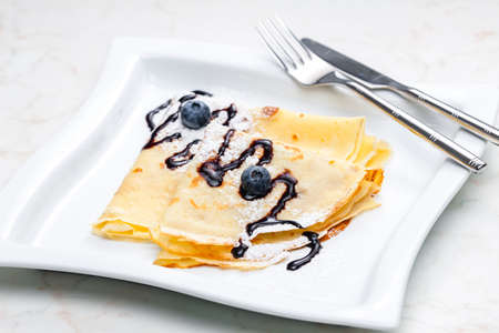 pancakes with blueberries and chocolate sauceの写真素材