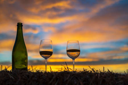 glass of wine with sunset in late summerの写真素材