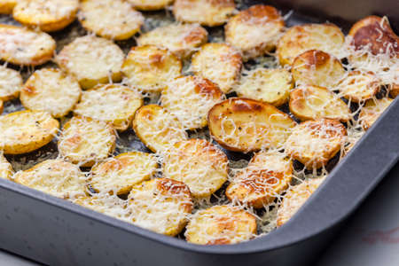 slices of potatoes baked with grated cheeseの写真素材
