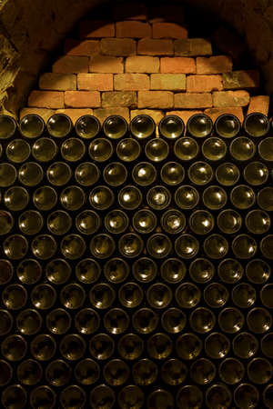 Area of stacked wine bottles in wine cellar, South Moravia Czech Republicの写真素材