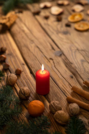 Traditional Czech Christmas on wood decoration with twig, candle, apple, orange, fruitの写真素材