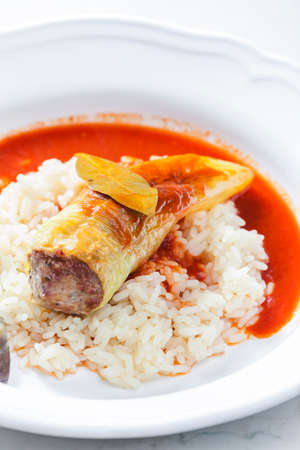 pepper stuffed with minced meat served with tomato sauce and riceの写真素材