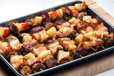 skewers with poultry meat, bacon and onionの写真素材