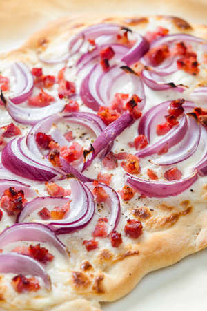 pizza with red onion, bacon and creamの写真素材