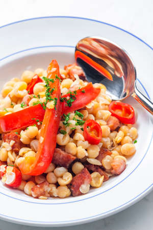 mixture of yellow peas and bacon served with red pepper and chilliの写真素材