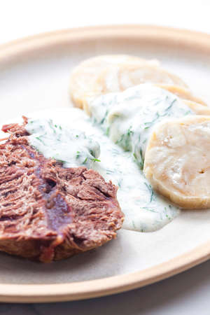 beef meat with dill sauce and dumplingsの写真素材