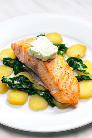 baked salmon with spinach leaves and potatoes