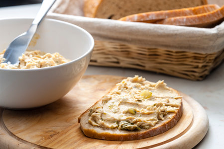 cracklings spread with pickled cucumber on slice of breadの写真素材
