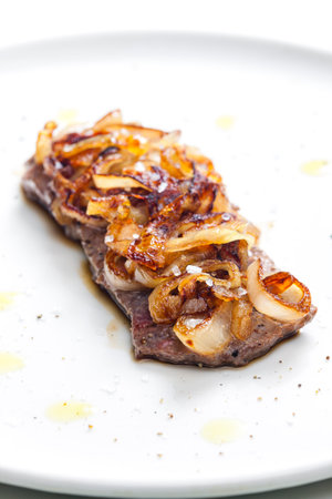 steak covered by caramelized onionの写真素材