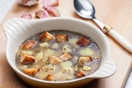 garlic soup with toasted bread and potatoesの写真素材