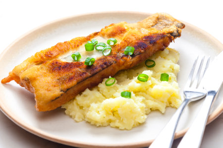 fried fish with mashed potatoes and spring onionの写真素材