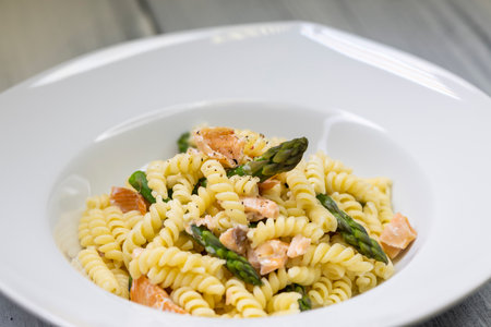 Spindle pasta with green asparagus and salmonの写真素材
