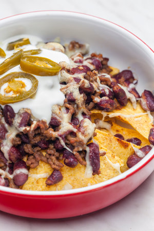 nachos baked with mince beef meat, cheese and red beansの写真素材