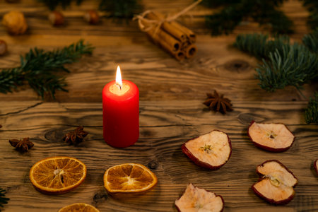 Traditional Czech Christmas on wood decoration with twig, candle, apple, orange, fruitの写真素材