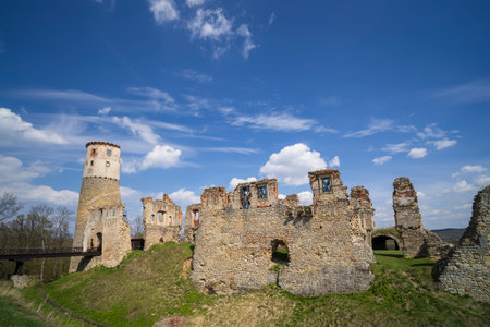 Remains of Zviretice Castle standing on a hill under a bright blue sky with some clouds, near Bakov nad Jizerou, Czechiaの写真素材
